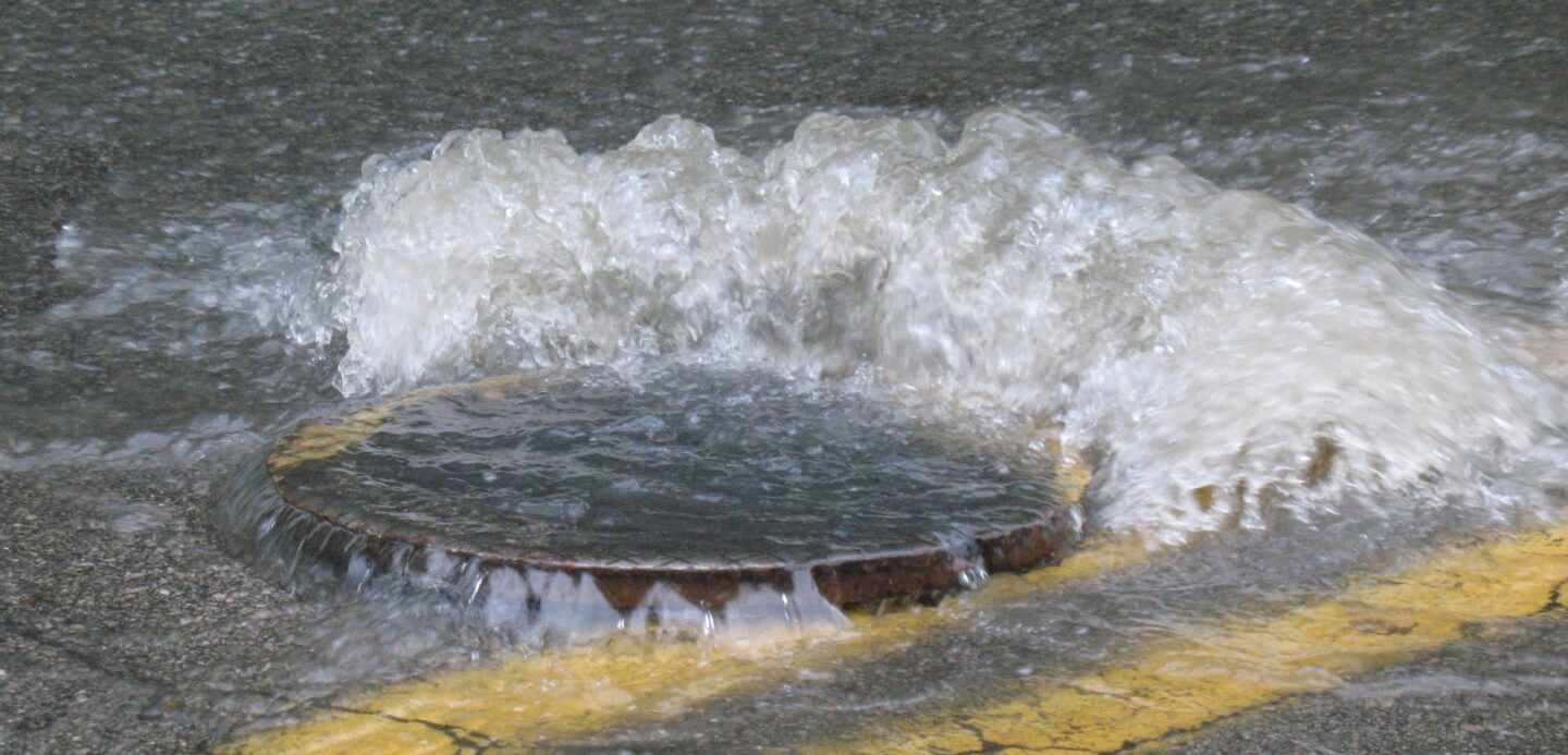 Flood risk assessment service in Yorkshire. A drain is overflowing.